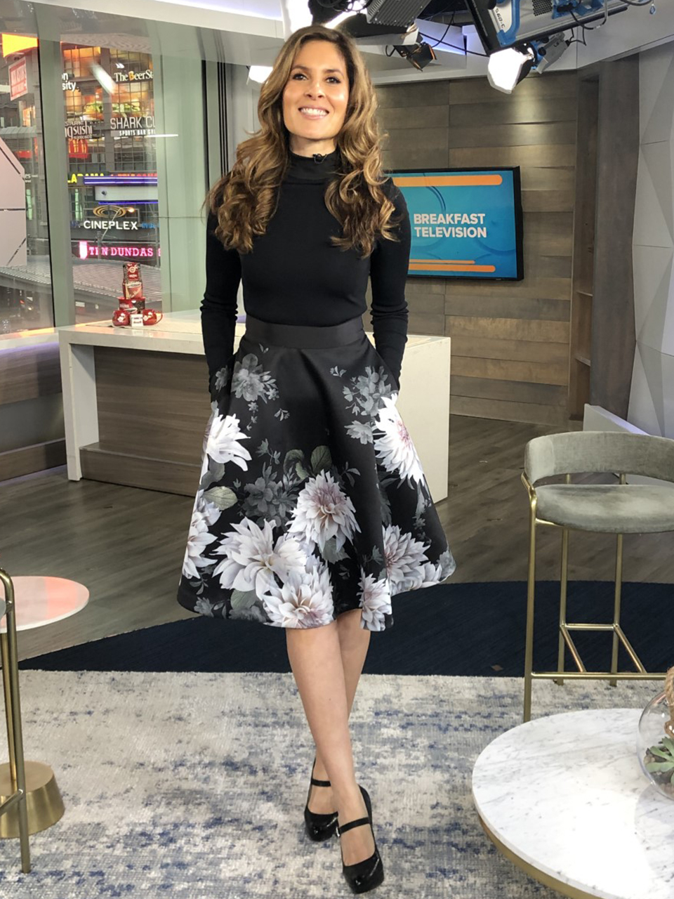 Dina wearing white flower print skirt with black top with heels