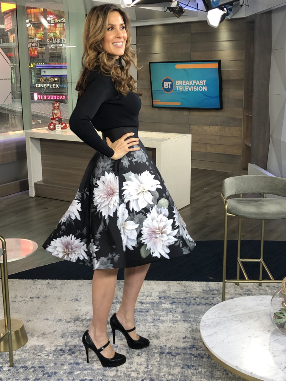 Dina wearing white flower print skirt with black top with heels - 2